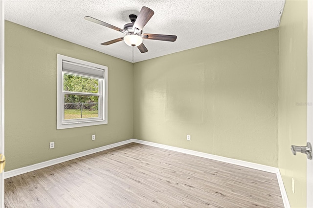 6989 SE 52nd Pl, Ocala, FL 34472 - empty room with wood finished floors, ceiling fan, a textured ceiling, and baseboards