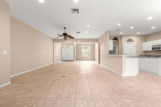 8961 SE 130th Loop, Summerfield, FL 34491 - unfurnished living room with a ceiling fan, recessed lighting, light tile patterned floors, and baseboards