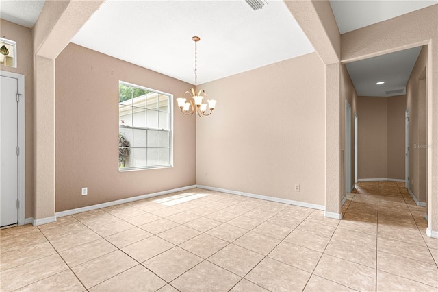 8961 SE 130th Loop, Summerfield, FL 34491 - empty room with a textured wall, a chandelier, light tile patterned floors, and baseboards
