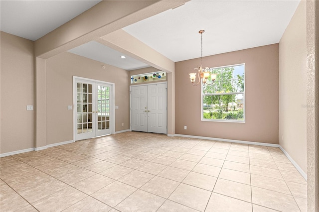 8961 SE 130th Loop, Summerfield, FL 34491 - spare room with a chandelier, light tile patterned flooring, and baseboards