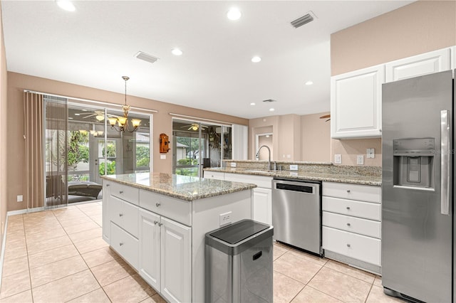 8961 SE 130th Loop, Summerfield, FL 34491 - kitchen featuring stainless steel appliances, light tile patterned floors, a ceiling fan, a sink, and a peninsula