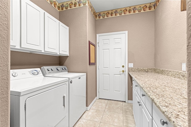 8961 SE 130th Loop, Summerfield, FL 34491 - laundry area with cabinet space, separate washer and dryer, a textured wall, light tile patterned floors, and baseboards