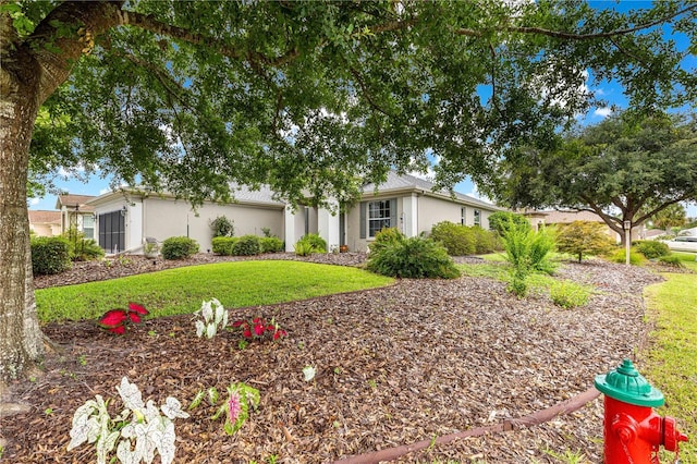 8961 SE 130th Loop, Summerfield, FL 34491 - view of front facade featuring stucco siding and a front lawn