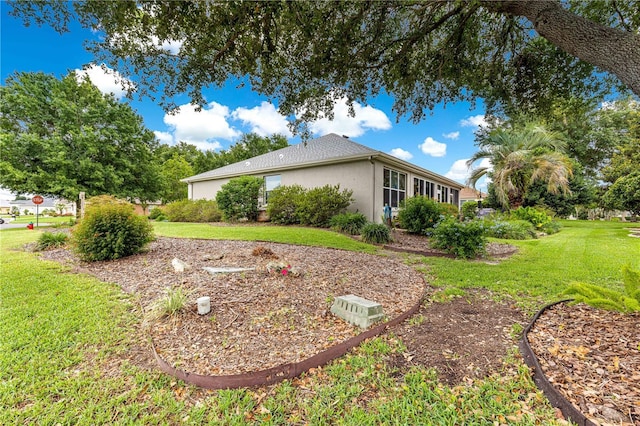 8961 SE 130th Loop, Summerfield, FL 34491 - view of home's exterior featuring stucco siding and a yard