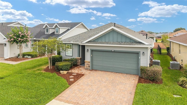 5651 NW 40th Pl, Ocala, FL 34482 - view of front of property with central AC unit, an attached garage, board and batten siding, and decorative driveway