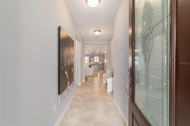 5651 NW 40th Pl, Ocala, FL 34482 - hall featuring light tile patterned floors and baseboards