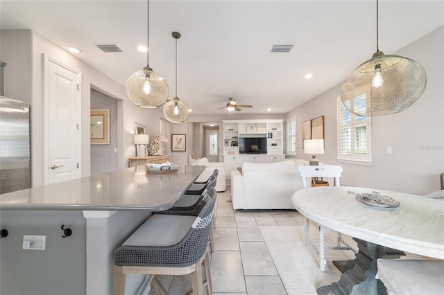 5651 NW 40th Pl, Ocala, FL 34482 - kitchen with a center island, ceiling fan, recessed lighting, light tile patterned floors, and hanging light fixtures