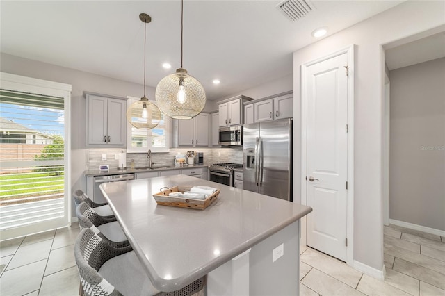 5651 NW 40th Pl, Ocala, FL 34482 - kitchen featuring appliances with stainless steel finishes, gray cabinetry, a sink, plenty of natural light, and recessed lighting