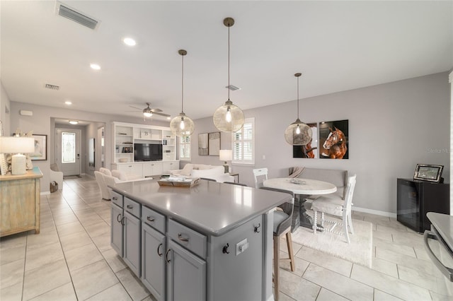 5651 NW 40th Pl, Ocala, FL 34482 - kitchen with a center island, plenty of natural light, gray cabinetry, a ceiling fan, and recessed lighting