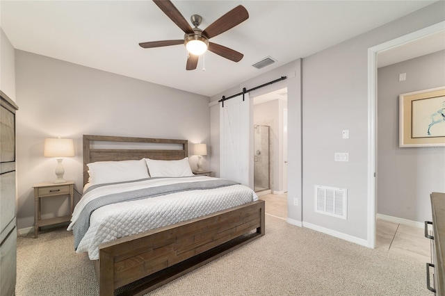 5651 NW 40th Pl, Ocala, FL 34482 - bedroom with a barn door, light colored carpet, baseboards, ceiling fan, and connected bathroom
