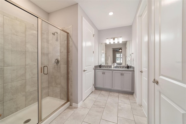 5651 NW 40th Pl, Ocala, FL 34482 - bathroom with double vanity, a stall shower, tile patterned flooring, and baseboards