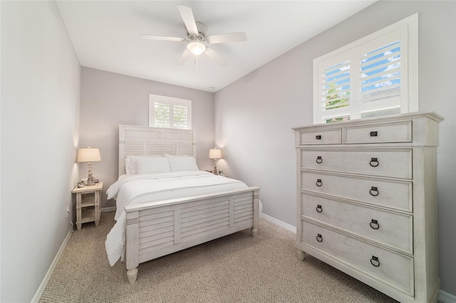 5651 NW 40th Pl, Ocala, FL 34482 - bedroom with baseboards, light colored carpet, and a ceiling fan
