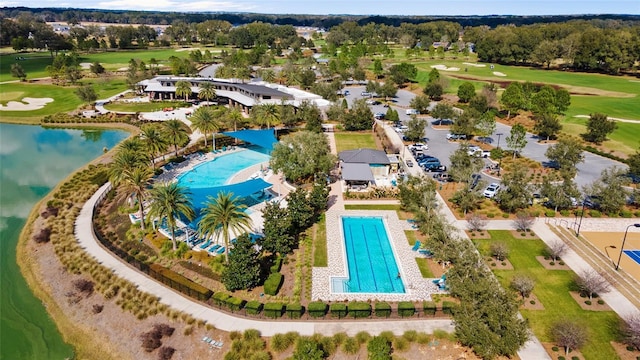 5651 NW 40th Pl, Ocala, FL 34482 - drone / aerial view of a pool, a local golf course, and a nearby body of water
