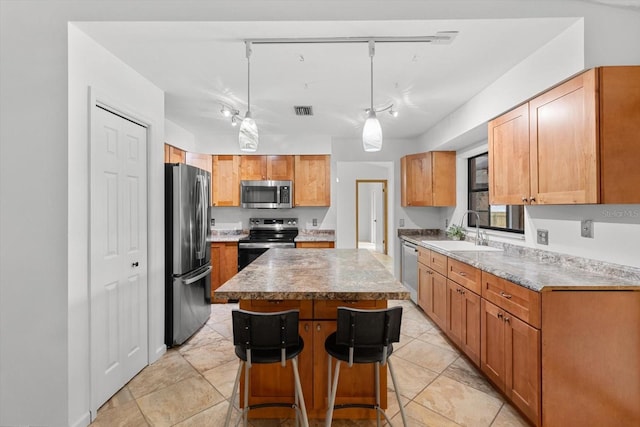 9606 N Caressa Way, Citrus Springs, FL 34434 - kitchen with stainless steel appliances, a sink, a kitchen island, a kitchen breakfast bar, and pendant lighting
