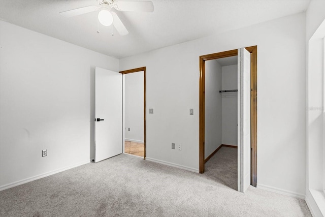9606 N Caressa Way, Citrus Springs, FL 34434 - unfurnished bedroom featuring light colored carpet, a walk in closet, baseboards, a ceiling fan, and a closet