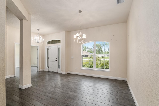 10910 SW 41st Ave, Ocala, FL 34476 - entryway with a chandelier, dark wood-type flooring, baseboards, and a textured wall