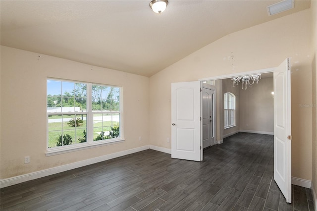 10910 SW 41st Ave, Ocala, FL 34476 - empty room with lofted ceiling, baseboards, dark wood finished floors, and a chandelier