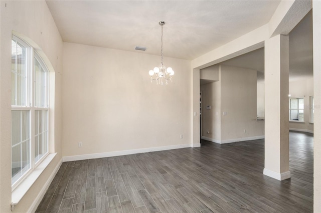 10910 SW 41st Ave, Ocala, FL 34476 - empty room featuring dark wood-type flooring, baseboards, and a chandelier