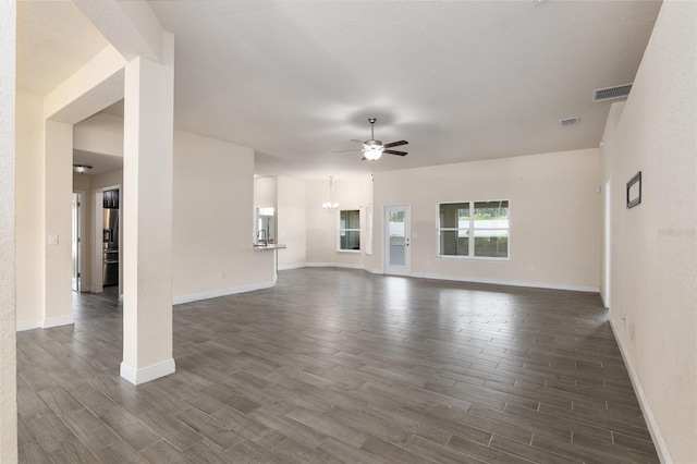 10910 SW 41st Ave, Ocala, FL 34476 - unfurnished living room featuring ceiling fan, dark wood-style floors, baseboards, and a chandelier