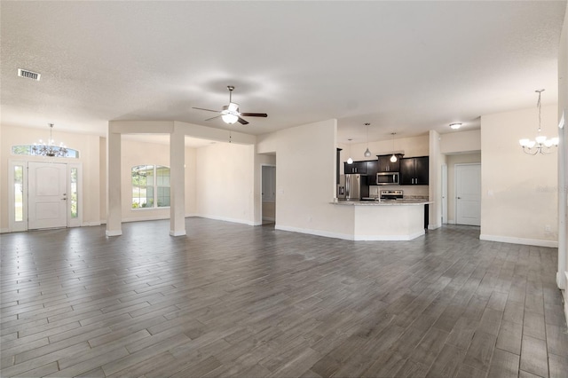 10910 SW 41st Ave, Ocala, FL 34476 - unfurnished living room featuring a chandelier, dark wood finished floors, ceiling fan, and baseboards