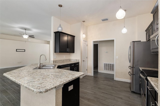 10910 SW 41st Ave, Ocala, FL 34476 - kitchen with stainless steel appliances, a sink, a peninsula, and dark wood finished floors
