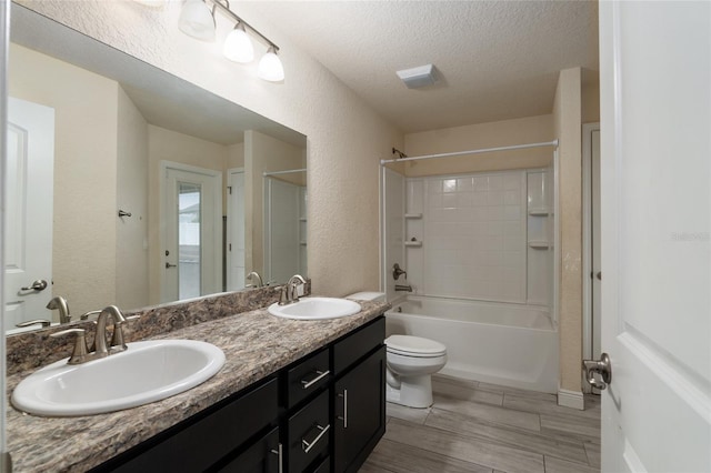 10910 SW 41st Ave, Ocala, FL 34476 - full bath featuring a textured ceiling, double vanity, toilet, a textured wall, and shower / washtub combination
