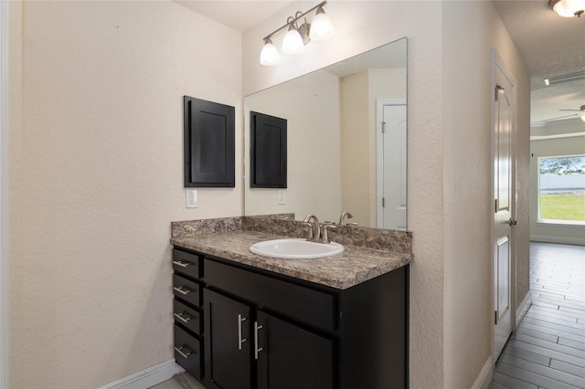 10910 SW 41st Ave, Ocala, FL 34476 - bathroom featuring vanity, baseboards, and a textured wall