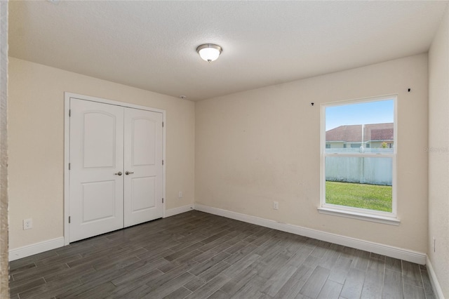 10910 SW 41st Ave, Ocala, FL 34476 - unfurnished bedroom featuring dark wood-type flooring, baseboards, and a closet