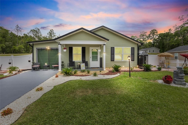 15324 SW 40th Place Rd, Ocala, FL 34481 - view of front facade with driveway, a garage, and a porch