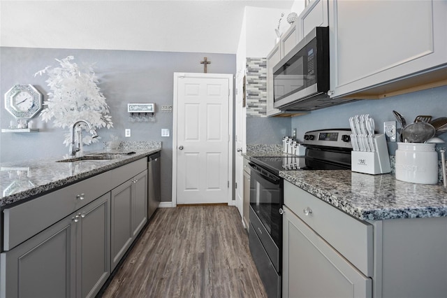 15324 SW 40th Place Rd, Ocala, FL 34481 - kitchen with appliances with stainless steel finishes, gray cabinets, dark wood-style flooring, a sink, and stone countertops