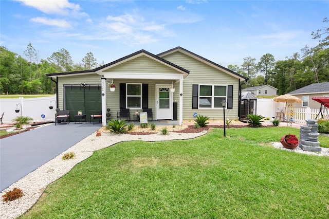 15324 SW 40th Place Rd, Ocala, FL 34481 - view of front of property with asphalt driveway, a porch, and a garage