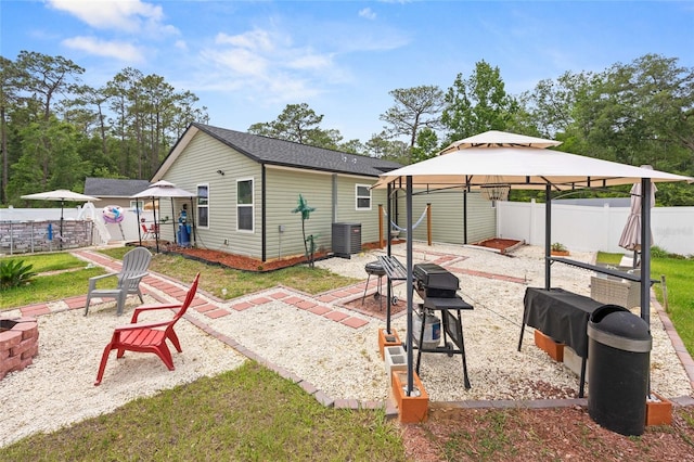 15324 SW 40th Place Rd, Ocala, FL 34481 - rear view of house with an outdoor fire pit, a gazebo, a patio area, central AC, and an outdoor structure