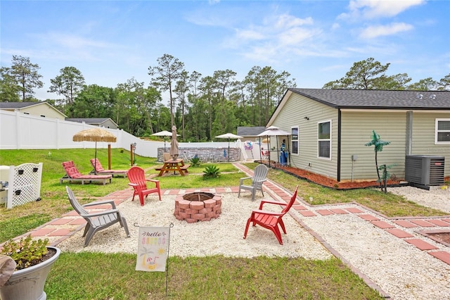 15324 SW 40th Place Rd, Ocala, FL 34481 - view of yard featuring a fire pit, central AC, and a patio area