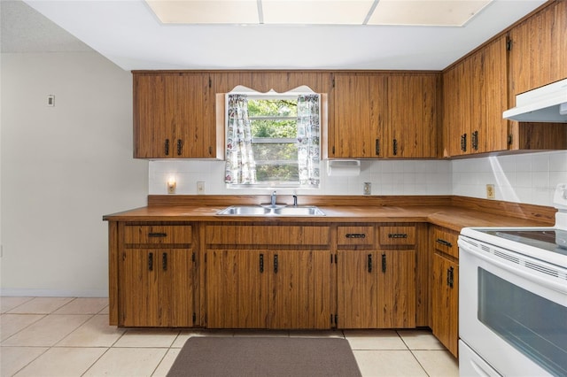 4467 SW Channel Heights Ct, Dunnellon, FL 34431 - kitchen featuring electric stove, a sink, brown cabinetry, light tile patterned floors, and decorative backsplash