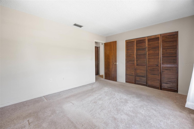 4467 SW Channel Heights Ct, Dunnellon, FL 34431 - unfurnished bedroom featuring light colored carpet, a closet, and a textured ceiling