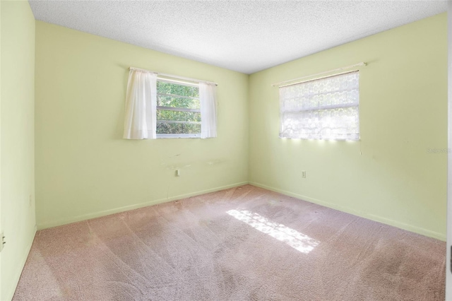 4467 SW Channel Heights Ct, Dunnellon, FL 34431 - empty room with carpet floors, a textured ceiling, and baseboards