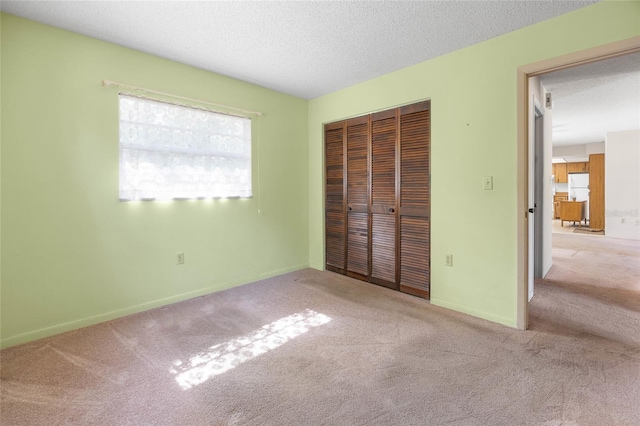 4467 SW Channel Heights Ct, Dunnellon, FL 34431 - unfurnished bedroom featuring carpet flooring, a closet, a textured ceiling, and baseboards