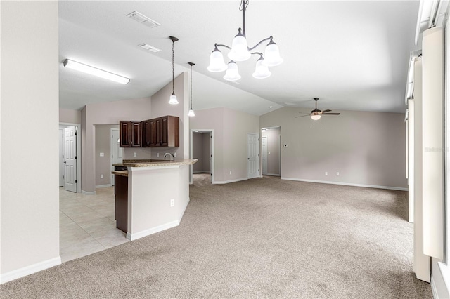 3445 SE 139th Ln, Summerfield, FL 34491 - kitchen featuring light colored carpet, vaulted ceiling, a chandelier, a ceiling fan, and dark brown cabinetry