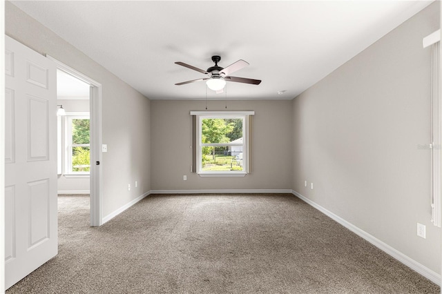 3445 SE 139th Ln, Summerfield, FL 34491 - empty room with healthy amount of natural light, carpet floors, ceiling fan, and baseboards