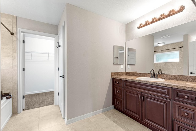 3445 SE 139th Ln, Summerfield, FL 34491 - full bath featuring vanity, a tile shower, a spacious closet, and tile patterned floors