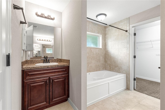 3445 SE 139th Ln, Summerfield, FL 34491 - full bathroom featuring vanity,  shower combination, tile patterned floors, a walk in closet, and a textured wall