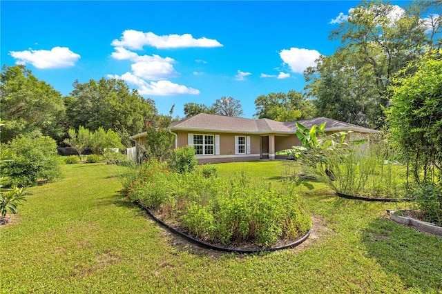 3445 SE 139th Ln, Summerfield, FL 34491 - back of property with stucco siding and a yard
