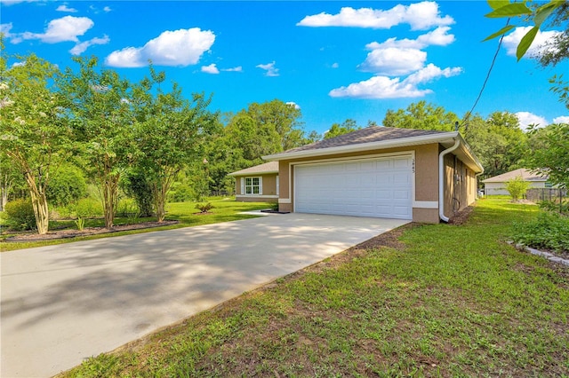 3445 SE 139th Ln, Summerfield, FL 34491 - view of front of house with an attached garage, concrete driveway, a front lawn, and stucco siding