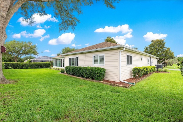 13715 SE 88th Ct, Summerfield, FL 34491 - back of house featuring a lawn and central air condition unit
