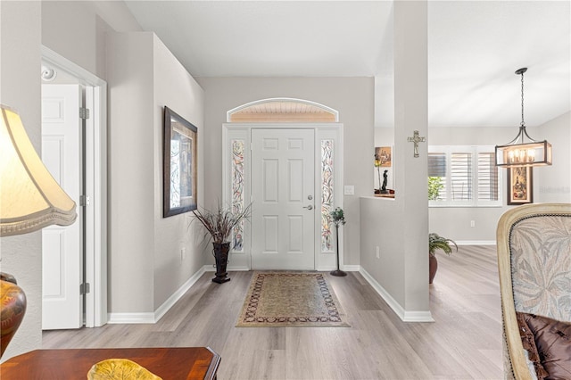 13715 SE 88th Ct, Summerfield, FL 34491 - entryway with wood finished floors, a chandelier, and baseboards
