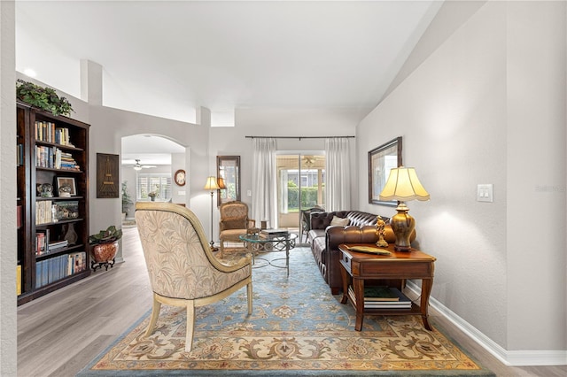 13715 SE 88th Ct, Summerfield, FL 34491 - living area with wood finished floors, baseboards, arched walkways, and ceiling fan