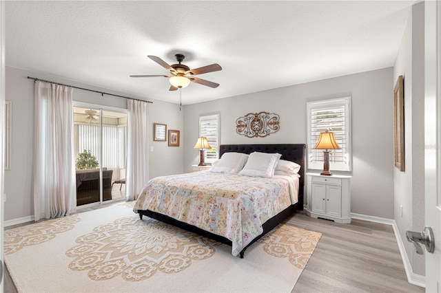 13715 SE 88th Ct, Summerfield, FL 34491 - bedroom featuring access to outside, baseboards, multiple windows, and light wood-type flooring