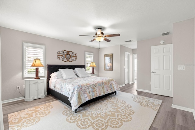 13715 SE 88th Ct, Summerfield, FL 34491 - bedroom featuring light wood finished floors, baseboards, and ceiling fan