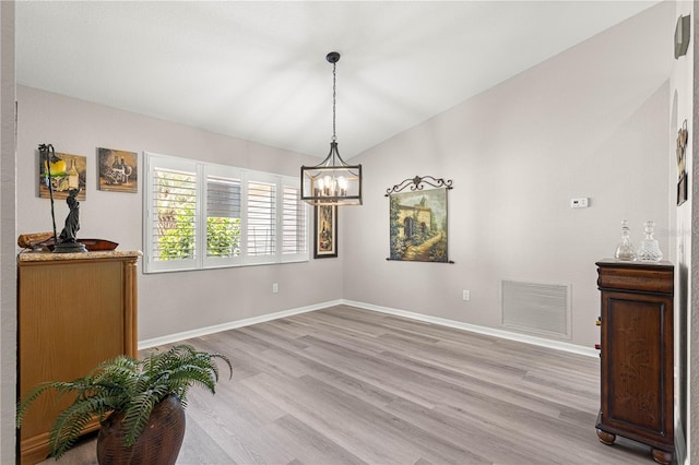 13715 SE 88th Ct, Summerfield, FL 34491 - dining room featuring light wood-type flooring, a chandelier, and baseboards