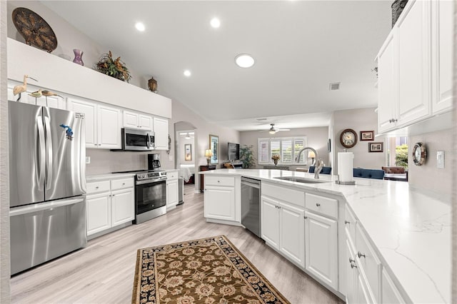 13715 SE 88th Ct, Summerfield, FL 34491 - kitchen featuring appliances with stainless steel finishes, a sink, a peninsula, recessed lighting, and light wood-type flooring